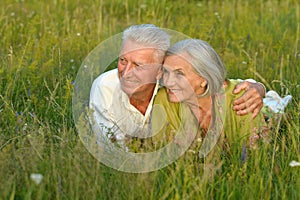 Senior couple lying on grass