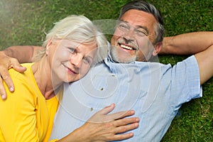 Senior couple lying on grass