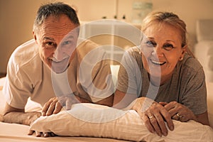 Senior couple lying together in bed.