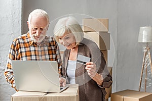 Senior couple making purchase online using