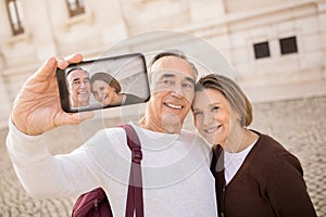 Senior Couple Making Selfie On Phone Standing In City Outdoor
