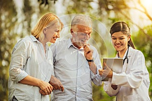 Senior couple talking to nurse or caregiver.