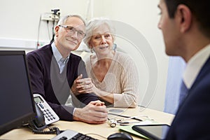 Senior Couple Meeting With Consultant In Hospital