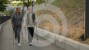 Senior couple nordic walking in park. Elderly family climbs a mountain together. Aging youthfully. People, sport and