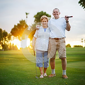 Senior couple out playing golf together portrait