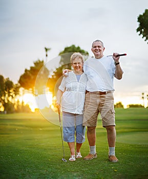 Senior couple out playing golf together portrait