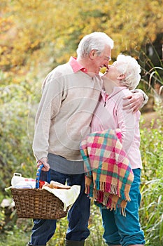 Senior Couple Outdoors With Picnic Basket