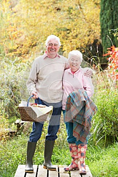 Senior Couple Outdoors With Picnic Basket