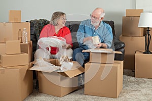 Senior Couple Packing or Unpacking Moving Boxes