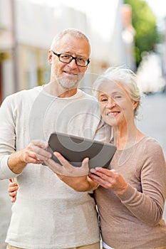 Senior couple photographing on city street