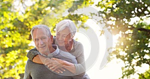 Senior couple, piggy back and happy outdoor at a park with love, care and support. A elderly man and woman in nature for