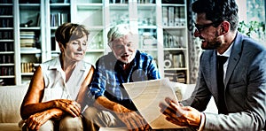 Senior couple planning their investments with financial advisor