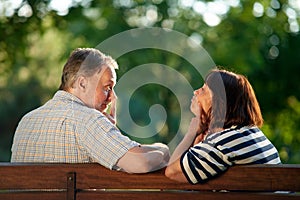 Senior couple play the ape outdoors.