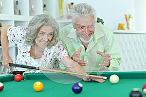 Senior couple playing billiard