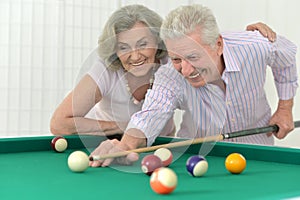 Senior couple playing billiard