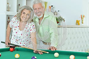 Senior couple playing billiard