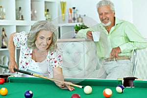 Senior couple playing billiard