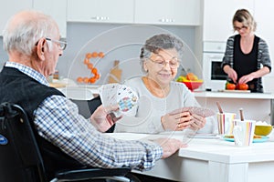 Senior couple playing cards