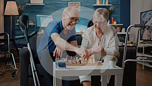 Senior couple playing chess board game with pieces