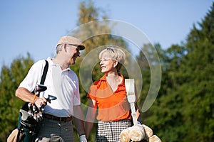 Senior couple playing Golf