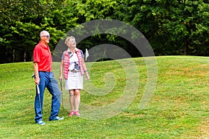 Senior couple playing golf in their leisure time