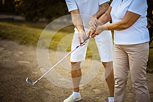 Senior couple playing golf together.