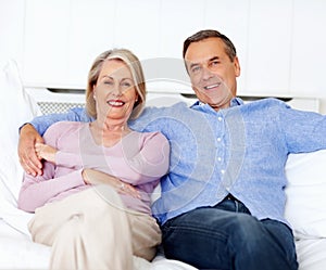 Senior, couple and portrait or happy on sofa with support, relationship and marriage in retirement home. Elderly, man