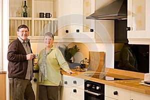 Senior couple portrait in modern designer kitchen