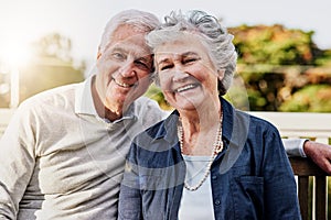 Senior couple, portrait and relaxing together outdoors or romantic retirement and park bench. Elderly, partners and