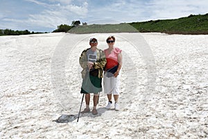 Senior couple posing on glacier of Lago-Naki plateau