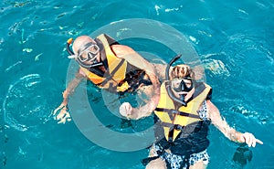 Senior couple posing for travel photo at snorkeling excursion in south east Asia during boat trip in exotic scenarios