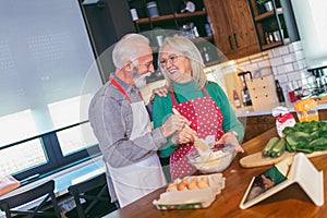 Senior couple preparing food in the kitchen