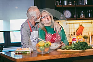 Senior couple preparing food in the kitchen