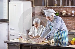 Senior couple preparing pastries in kitchen at home