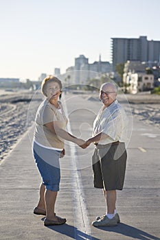 Senior Couple On Promenade Holding Hands