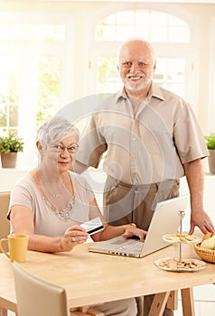 Senior couple purchasing on Internet