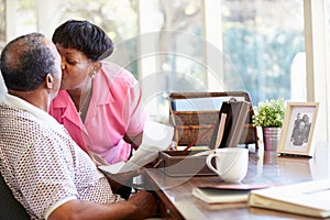 Senior Couple Putting Letter Into Keepsake Box