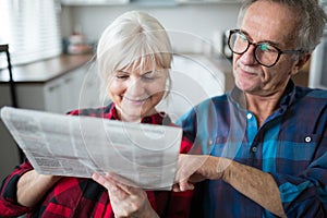 Senior couple reading newspaper together