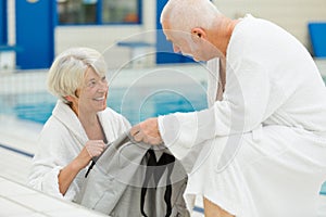 Senior couple in relax at therme with swimming pool photo