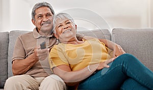 Senior couple, relax and watching tv on sofa in home living room. Retirement, love and elderly, man and woman streaming