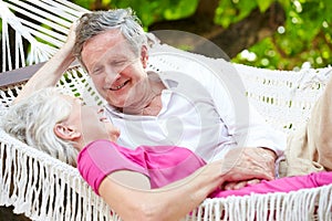 Senior Couple Relaxing In Beach Hammock