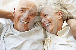 Senior Couple Relaxing In Bed