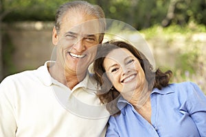 Senior Couple Relaxing In Garden Together