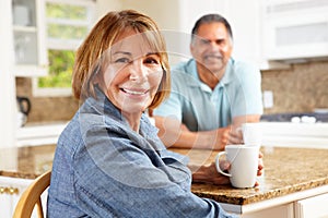 Senior couple relaxing in kitchen