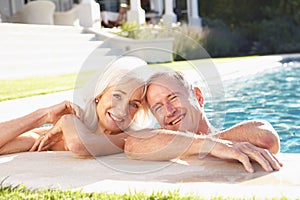 Senior Couple Relaxing by Outdoor Pool