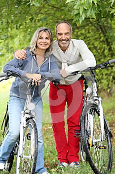 Senior couple relaxing after riding bicycle