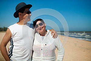 Senior couple relaxing by the sea on sunny day