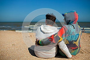 Senior couple relaxing by the sea on sunny day