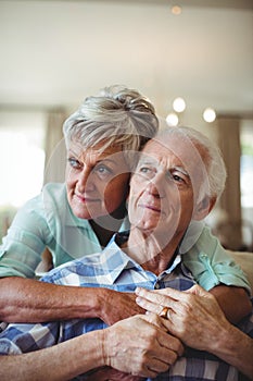 Senior couple relaxing on sofa in living room