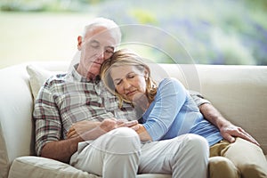 Senior couple relaxing on sofa in living room